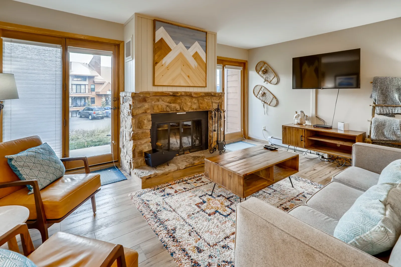 Silverthorne living room with a stone fireplace and mountain artwork